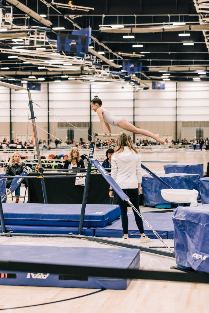 Young gymnast doing uneven bars