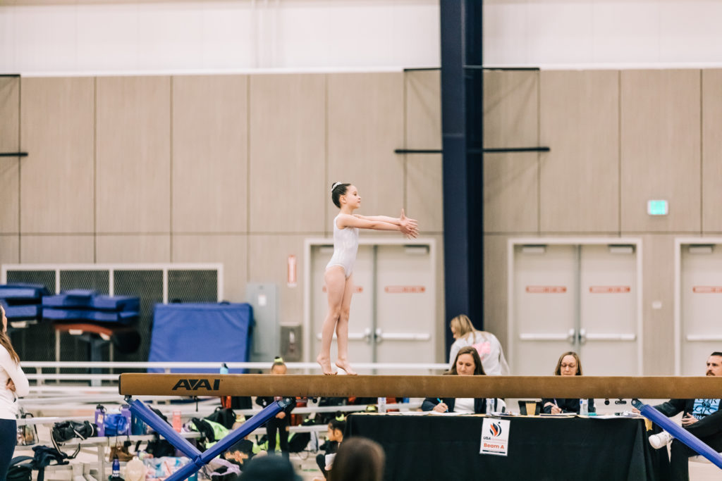  Young gymnast doing her beam routine