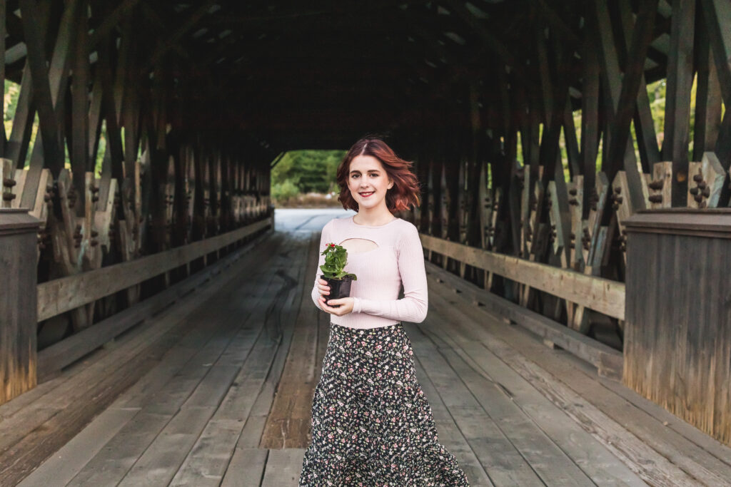 Vanessa with one of her joys (a plant) and a beautiful wooden covered bridge in New Hampshire.