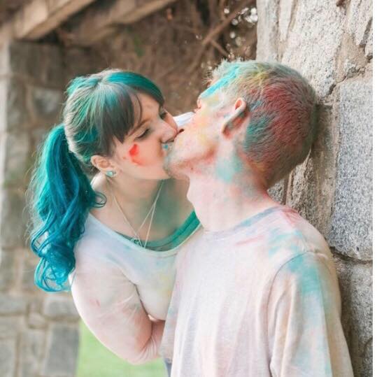 Engagement session in Sacramento CA. Couple covered in chalk dust and kissing.