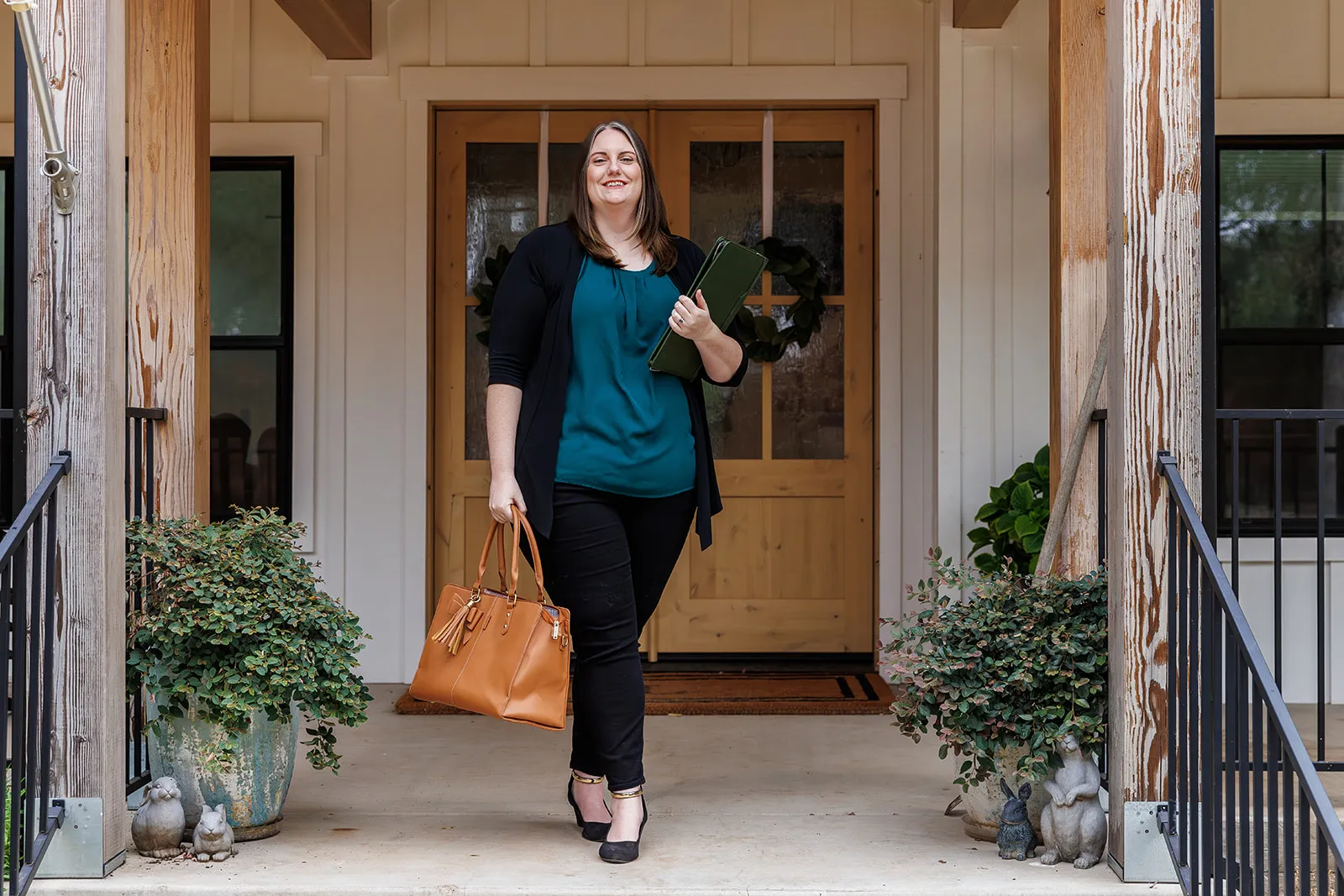 Brand photography with real estate agent Chaun Amber in Auburn CA. Client on porch ready to show houses