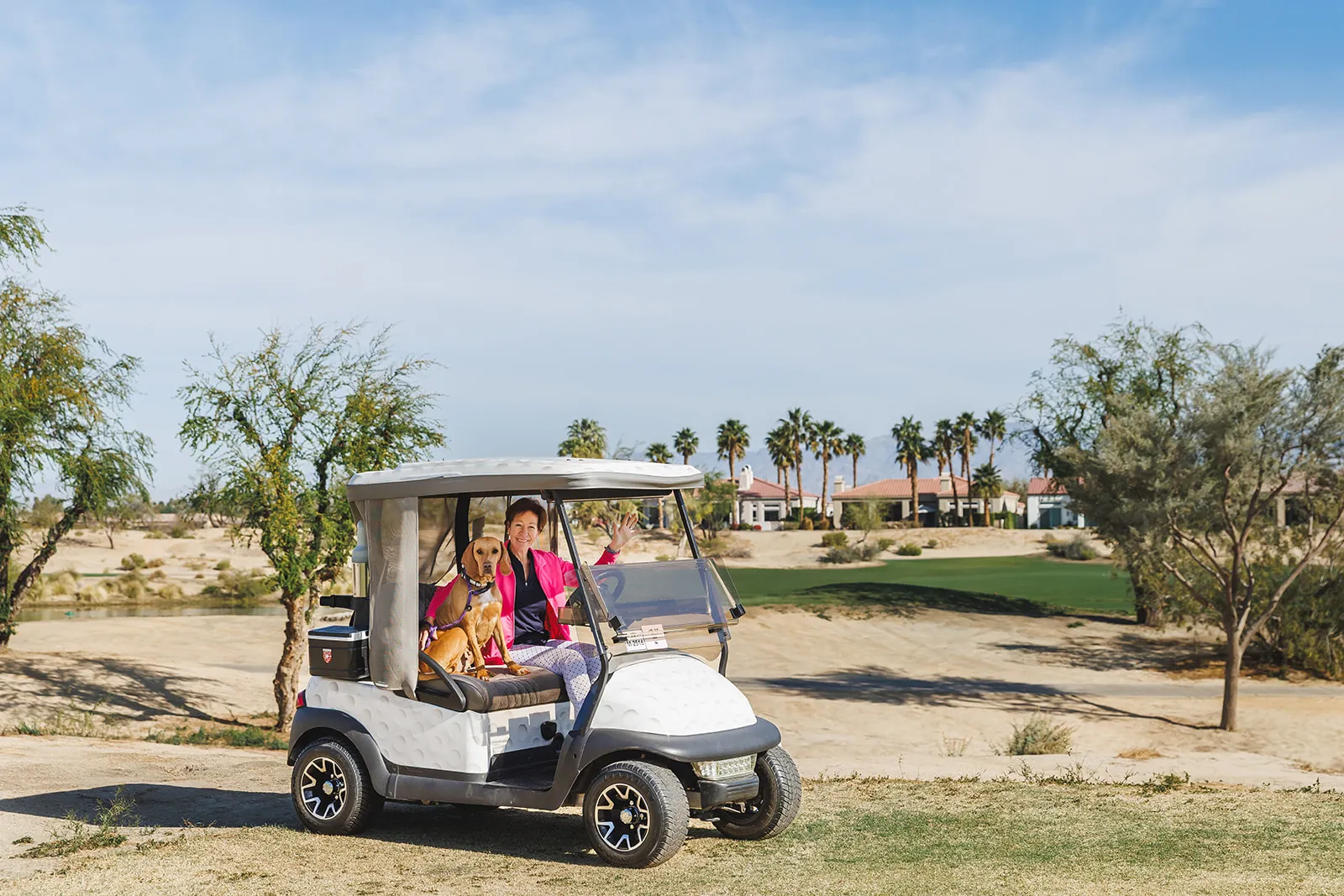 Brand photography session with Anne Stark with Berkshire Hathaway Home Services in Indian Wells CA. Anne is in the golf cart with her dog Cookie on a golf course in La Quinta CA