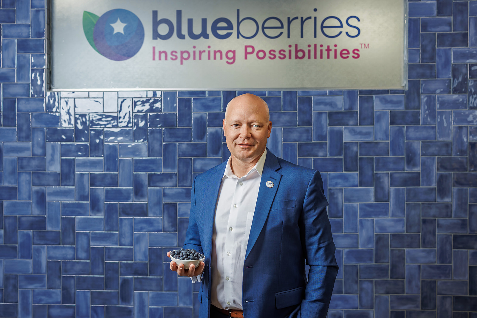 Headshot of Kasey Cronquist from the North American Blueberry Council in Folsom CA holding a bowl of blueberries