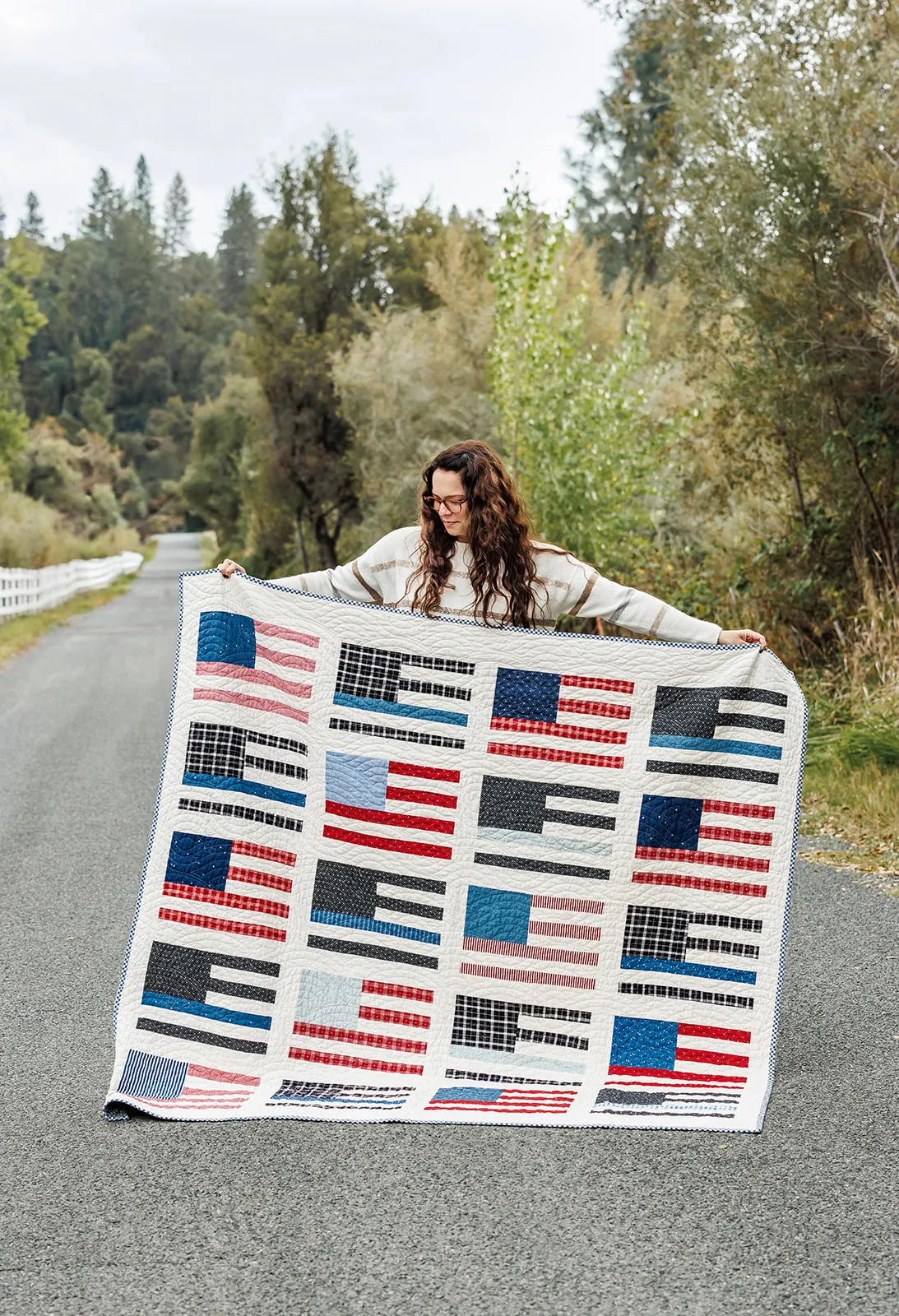 American flag quilt being held by owner Kayla Leal from brand session in Auburn CA