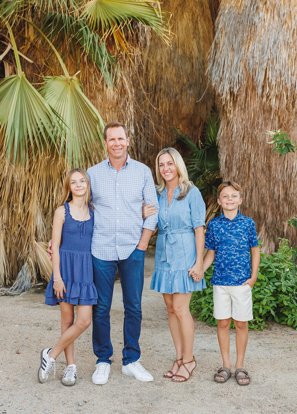 Family session in Palm Desert CA at the Desert Willow golf course at sunset. Family of 4 snuggled up taken by Ann Keen Photography.